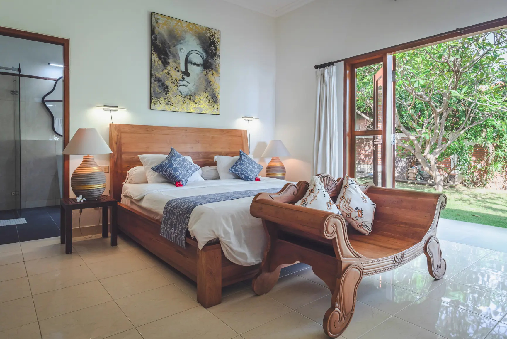 Master bedroom with king-sized bed, view of the open garden door