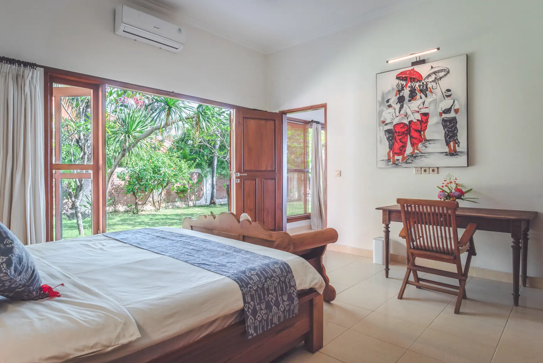 Master bedroom desk corner with open doors to the garden