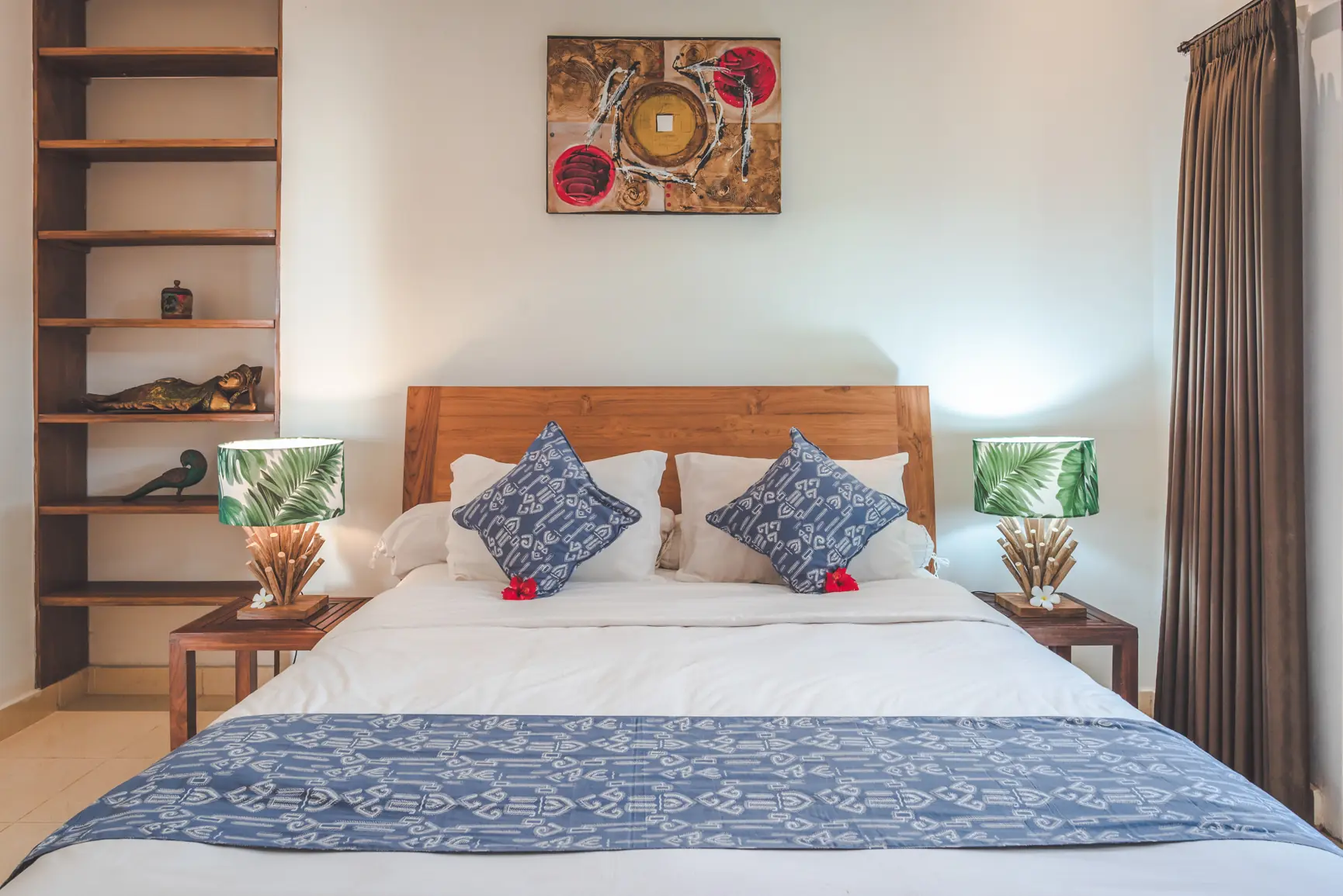 Ocean bedroom queen bed with wooden bookshelf and leaf-pattern lamps