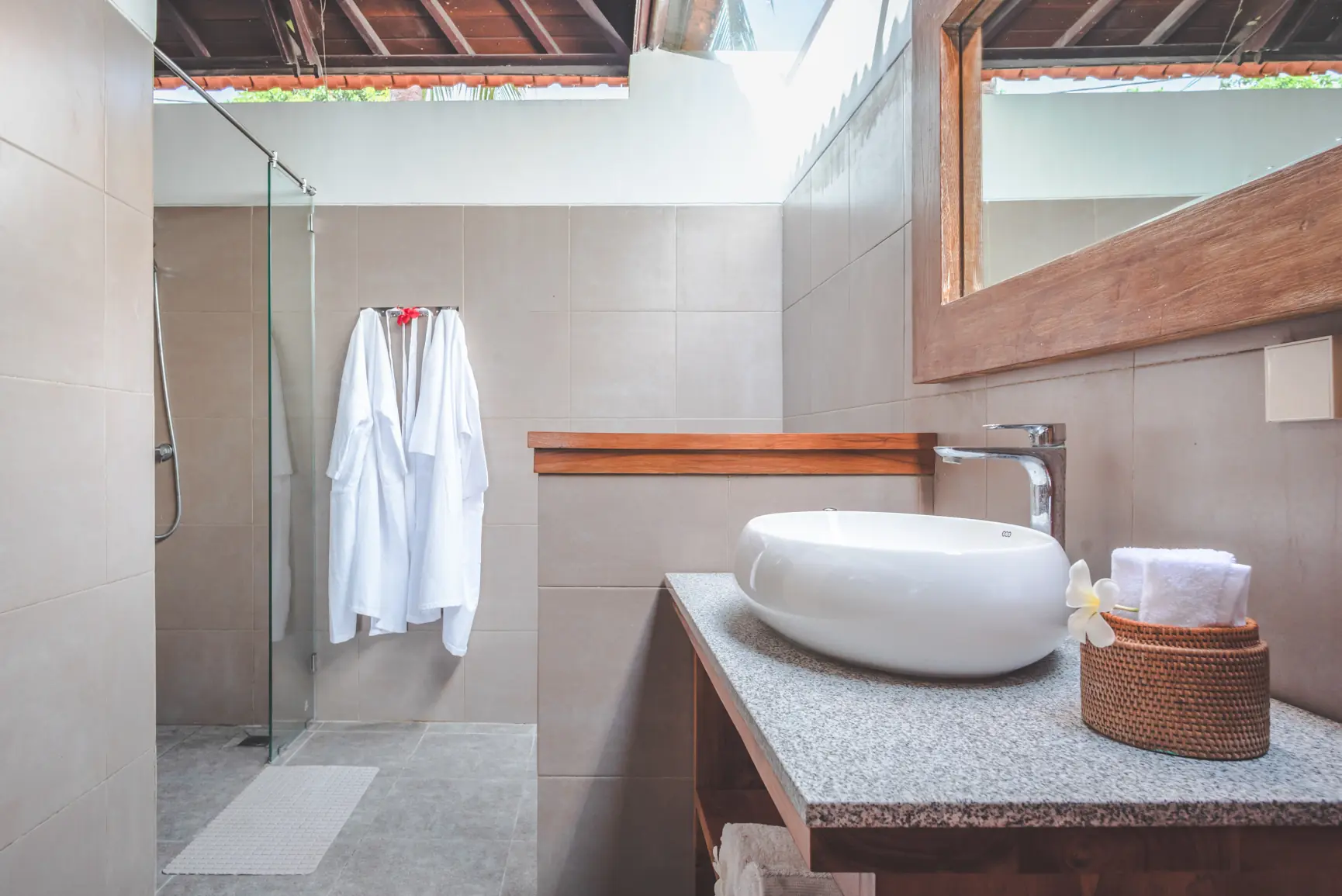 Ocean bedroom outdoor-style bathroom with hanging robes and walk-in shower