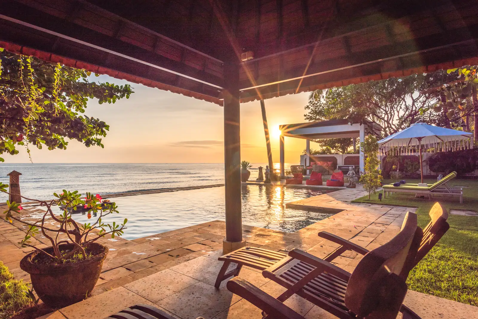 Sunrise view of the pool and covered terrace at Primavera Beach House.